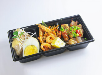 Savory Asian Bento Snack Box include Shrimp, Chicken, Egg and Lemon isolated on white background side view of Takeout Meal