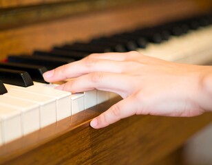 Fototapeta premium A hand playing piano keys