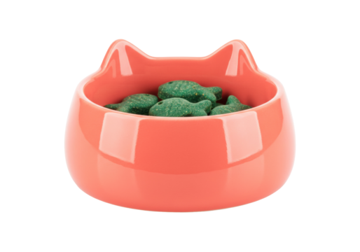 Salmon-colored cat bowl with green fish-shaped treats isolated, pet food container for domestic animals and feline care