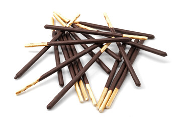 Pile of crunchy biscuit sticks dipped in dark chocolate on white background. Sweet snack, dessert, and confectionery concept. Perfect for food, sweets, and chocolate lovers.