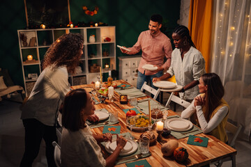Friends setting thanksgiving table enjoying togetherness and festivities