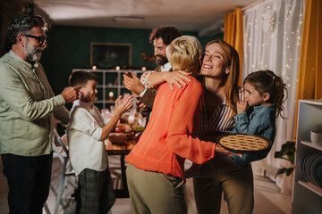 Family celebrating thanksgiving, hugging and enjoying dessert