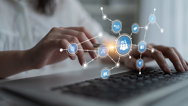A close-up of hands typing on a laptop, surrounded by digital network icons representing social interaction and communication, highlighting modern technology role in connectivity. Tessel - Powered by Adobe