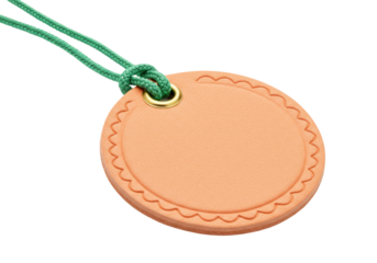Round peach tag with scalloped edge isolated, green rope and gold eyelet, blank label for price or gift on no background