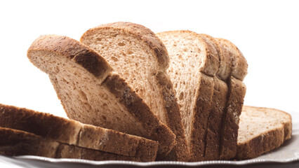 Sliced wholemeal bread on a white background. Healthy bakery product rich in fiber, ideal for breakfast, sandwiches, toast, and balanced diets.