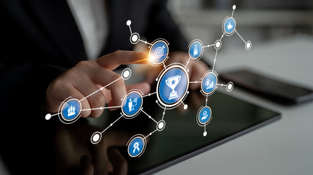 A professional person uses a tablet displaying digital marketing and social media icons, representing modern business strategies in a collaborative workspace. Tessel - Powered by Adobe