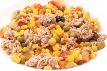 Close-up of fresh tuna salad with corn, peas, carrots, and black olives. Nutritious and colorful dish, ideal for healthy eating, Mediterranean cuisine, and quick light meals.