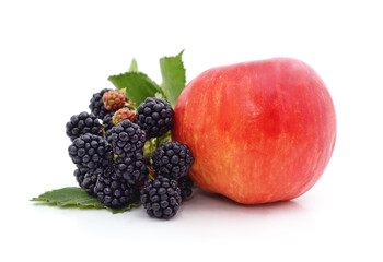 One red apple and a ripe blackberry.