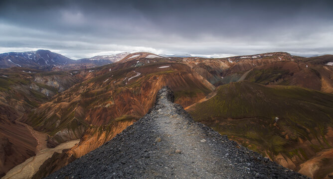 Dramatic landscape view from a ledge on the summit of a mountain, Landmannalaugar, Southern Region, Iceland