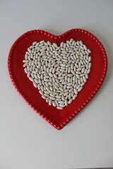 heart full of organic white beans. healthy eating concept