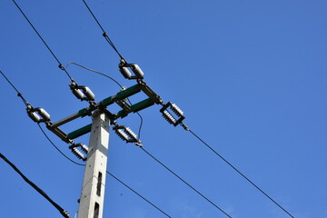 high voltage power lines against blue sky