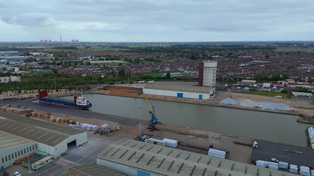 Aerial drone view of busy shipping port, industrial buildings and wharfs for loading and unloading cargo ships and tankers near Goole, United Kingdom