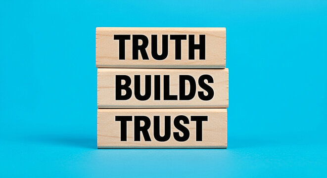 Wooden blocks stacked with the words truth builds trust on a bright blue background concept of integrity