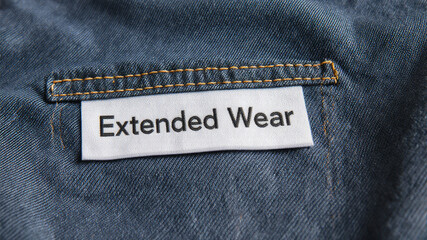 Extended wear patch stitched into seam on back of rugged denim jacket