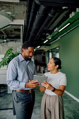 Multiracial business colleagues collaborating on a digital tablet, discussing ideas during a meeting in a contemporary workspace
