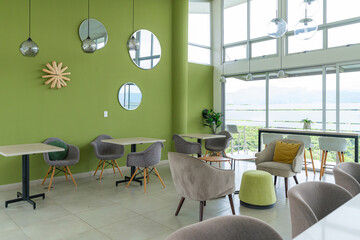 Modern lounge with green walls and panoramic mountain view