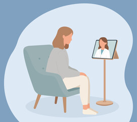A woman sits in a chair having an online consultation with her doctor via a video call on a tablet, representing modern telemedicine and virtual healthcare