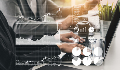 Two business professionals work together on a laptop, analyzing financial data and digital charts, showcasing teamwork and strategy in a modern office space. Impute