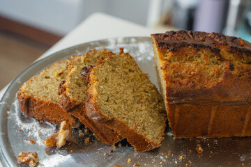 Sliced homemade walnut bread on metal tray