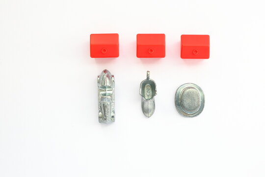 Monopoly board game concept. Tokens figures car, shoe, hat and red hotel. Above angle shot photo. Close up and isolated.