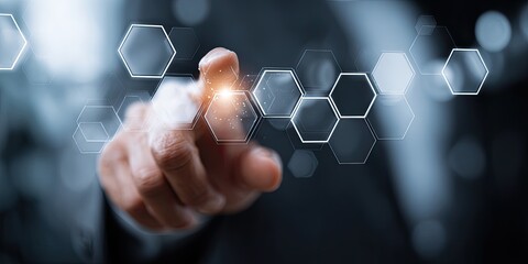 Close-up of a hand interacting with a digital interface of interconnected hexagonal shapes