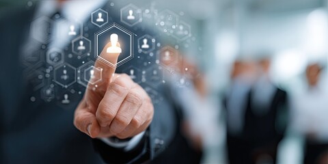 Close-up of a hand touching a highlighted person icon, overlaid on a blurred group of business people. A network of icons representing people surrounds the highlighted individual