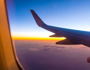 Obraz premium Airplane window view of sunrise over clouds