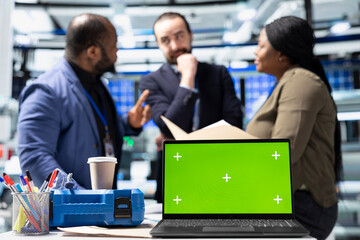 Coworkers brainstorming solutions with mockup display in solar plant, advancing industrial goals through collaboration and corporate responsibility. Team of engineers share insight.