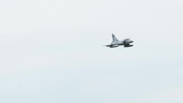 Mirage 2000 flying high over the airfield in the afternoon
