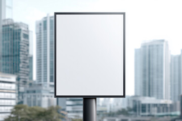 Vertical blank billboard mockup in a modern urban setting with tall buildings in the background, ideal for portrait-format advertising and outdoor promotional content
