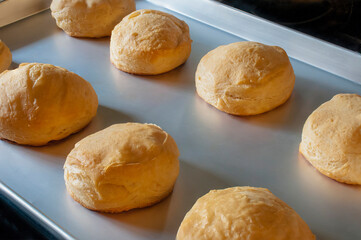 Freshly baked biscuits in an aluminum tray, ready to accompany meals or for desserts