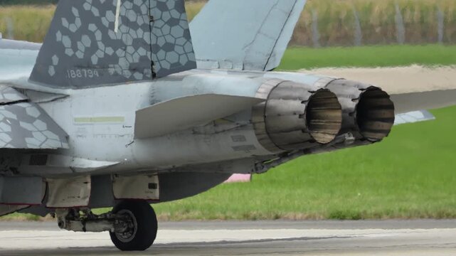F-18 jet displays impressive design and detail on the runway during a sunny day