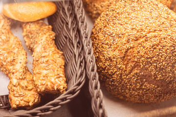 Freshly baked bread and pastries displayed in a rustic basket at a cozy bakery during morning hours