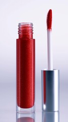 Glamorous close-up of a tube of sparkling red lip product with a fuzzy applicator.