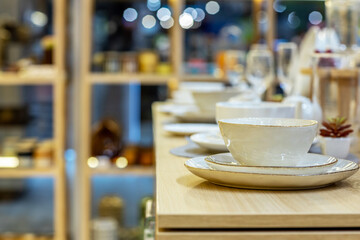 Shelves with porcelain tableware in the gift department of a shopping center