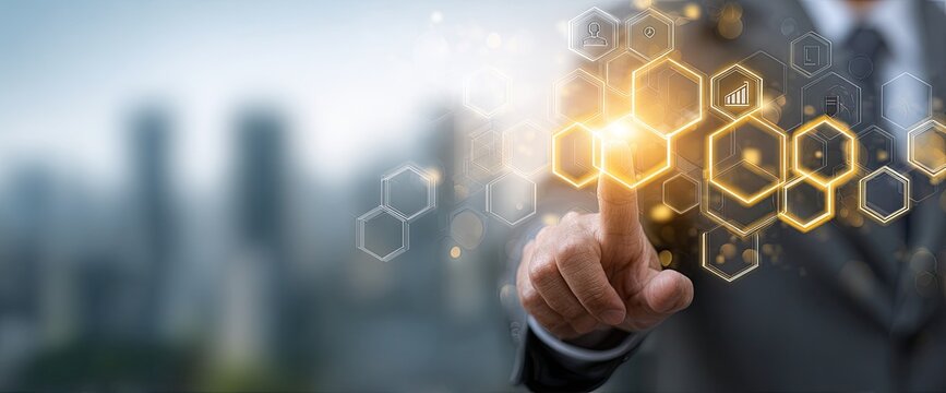 Businessperson interacts with a digital network of interconnected hexagons, overlaid on a blurred cityscape