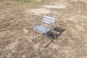Metallic white chair on the gray background