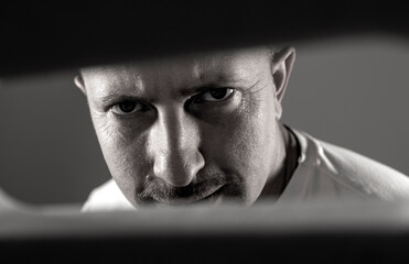 Close-up photo of male eyes. Shadow. Man face. Male. Background. Stress