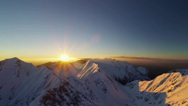Majestic Sunrise Over Snowy Mountain Peaks with Cinematic Aerial View