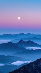 Moon over layered blue mountains with low-lying fog