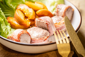Bacon wrapped chicken fillet with peaches