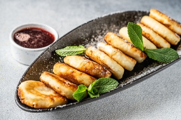 Cottage cheese syrniki with mint and berry sauce