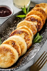 Golden syrniki with berry sauce and mint