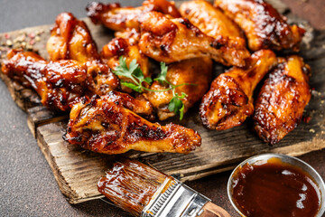 Closeup of glazed chicken wings with barbecue sauce