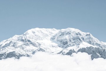 Obraz premium Snowy mountain peak rising above clouds