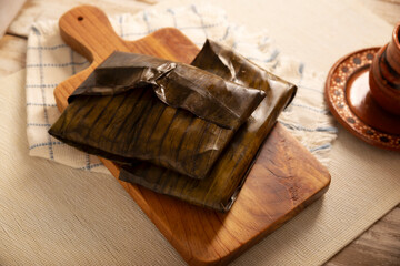 Oaxacan Tamale. Prehispanic dish typical of Mexico and some Latin American countries. Corn dough wrapped in banana leaves. The tamales are steamed.