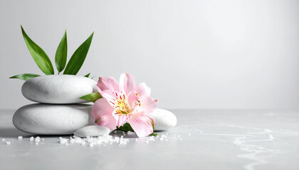 Smooth white stones stacked with green leaves and delicate pink flower create calming spa scene with scattered salt crystals on light marble surface, evoking peaceful relaxation
