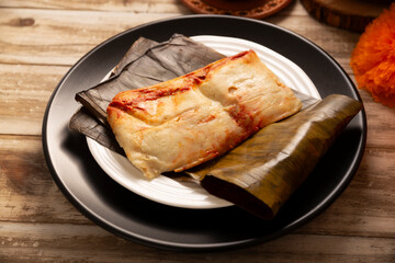 Oaxacan Tamale. Prehispanic dish typical of Mexico and some Latin American countries. Corn dough wrapped in banana leaves. The tamales are steamed.