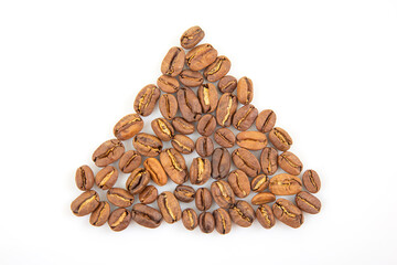 Coffee beans arranged in a triangular shape on a plain background for creative display