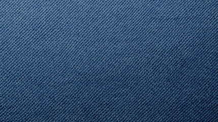 Macro photograph shows the detailed texture of dark blue denim fabric, offe a close view of its diagonal weave and subtle tonal variations.